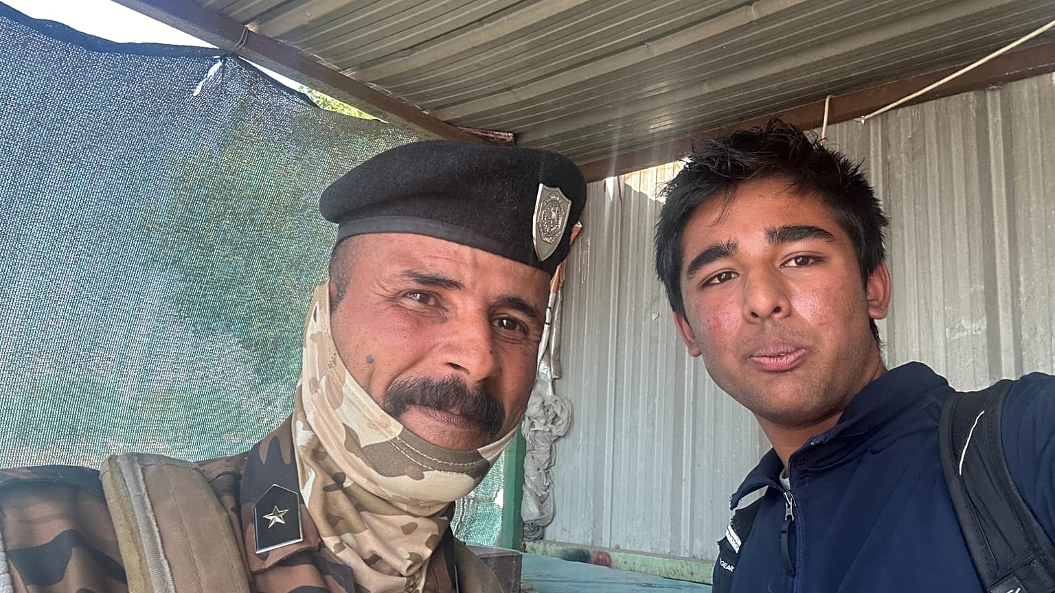 Arjun Malaviya with a military guard in Iraq
