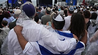 People attend a ceremony to mark the National Day of Reflection for victims and survivors, at Bondi Beach in Sydney, 21 December 2025