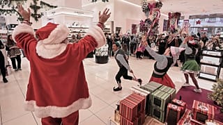 People portraying Santa and his elves perform in the cosmetics department at a Nordstrom department store, in New York, 8 December 2025