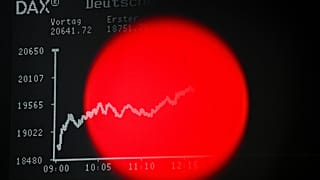 A red light of a TV camera is seen in front of the display board with the DAX stock index. Frankfurt Stock Exchange. 7 April 2025.