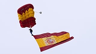 FILE: A paratrooper member of Spain's Armed Forces carries a Spanish flag during a military parade marking 'Dia de la Hispanidad' or Hispanic Day, in Madrid, 12 October 2025