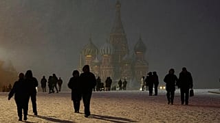 Snow falls on people walking through Red Square in Moscow, 8 April, 2025