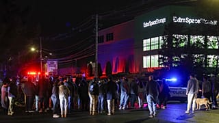 People gather outside a storage facility where a suspect in the shooting at Brown University was found dead, Thursday, Dec. 18, 2025, in Salem, N.H.