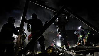 Rescue workers clear the rubble of a residential house destroyed by a Russian drone strike in Zaporizhzhia