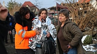 Local residents look at a residential house destroyed after a Russian attack on Zaporizhzhia, Ukraine, Friday, Dec. 19, 2025.