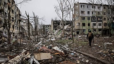 A soldier walks through the ruins of the town of Kostyantynivka, in the Donetsk region, Ukraine. Saturday Dec. 20, 2025