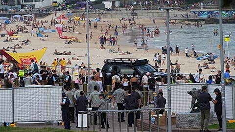 Security gathers at a gate at Bondi Beach in Sydney ahead of a ceremony to mark National Day of Reflection for victims and survivors from the Bondi shooting, Dec. 21, 2025.